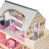 A close-up view of a wooden dollhouse with multiple floors and furniture. Voir les images du produit
