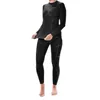 A woman is modeling a black long-sleeved thermal shirt and matching leggings. Náhled obrázku produktu