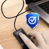 A hand is shown using a USB fingerprint scanner connected to a laptop, with a security badge overlay. Produktbild-Vorschau