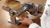 A person is using a pasta maker to flatten dough. Produktbild-Vorschau