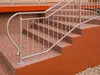 A close-up view of a staircase with a metal railing and textured steps. Produktbild-Vorschau