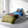 A child's bed with bedding featuring a tractor print, set in a bedroom with a window and a floor lamp. Produktbild-Vorschau