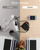 A split image showing two different charging setups. The left side displays a messy arrangement of white cables and a white power strip, labeled 'Andere'. The right side shows a cleaner setup with a black charging hub and a smartphone, labeled 'Voomy'. Bot Produktbild-Vorschau