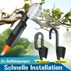 A camping shower head is shown attached to a tree branch, with water spraying. Two black mounting brackets are displayed separately. Text overlays highlight features and installation. Produktbild-Vorschau