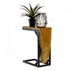 A wooden side table with a metal frame, holding a potted plant and a candle holder with a candle. Voir les images du produit