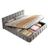 A bed with its storage compartment open, showing stored items. Voir les images du produit