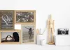 A collage of four photo frames arranged on a white surface, with a wooden mannequin and a camera to the right. Náhled obrázku produktu