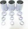 Three white cylindrical heating thermostats and their disassembled parts are arranged on a white surface. Produktbild-Vorschau