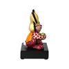 A side view of a colorful rabbit figurine on a black base. Produktbild-Vorschau