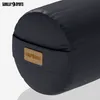 A close-up view of a black yoga bolster with a brown leatherette logo patch. Náhľad obrázku produktu