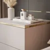 A close-up view of a bedside table with decorative items on top. Produktbild-Vorschau