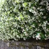 A dense hedge of white jasmine flowers cascading over a stone wall. Podgląd zdjęcia produktu