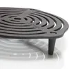 A close-up shot of a black cast iron trivet with a spiral design. Produktbild-Vorschau