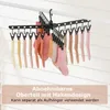 A black sock drying rack with multiple socks hanging from it, set against a white and light gray slatted background. Anteprima dell’immagine prodotto