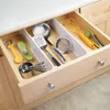A kitchen drawer filled with various utensils, organized with dividers. Produktbild-Vorschau