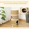 A cat tree with two cats, one peeking out of a hole and another with its tail visible. There is also a small white ball on the floor. Produktbild-Vorschau