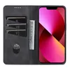 A black leather wallet-style phone case for an iPhone 14 Plus, open to reveal card slots and a folded banknote, with the phone screen displaying a colorful abstract wallpaper. Produktbild-Vorschau