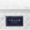 A close-up view of a mattress with a label. Produktbild-Vorschau