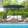 An outdoor patio scene with furniture and a large umbrella next to a swimming pool. Anteprima dell’immagine prodotto