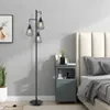 A modern bedroom with a floor lamp next to a nightstand and bed. Produktbild-Vorschau