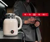 A person holding a glass of beverage next to a cream-colored electric kettle with a digital display. Podgląd zdjęcia produktu