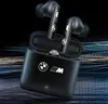 A pair of black wireless earbuds with a charging case, both featuring BMW M branding, set against a dark, abstract background with streaks of blue and white light. Anteprima dell’immagine prodotto