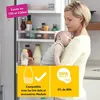 A mother holding her baby in front of an open refrigerator. Produktbild-Vorschau