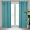Two teal curtains hang on a window rod in front of a window. A potted plant is visible on the right side of the image. Voir les images du produit