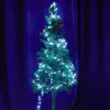 A decorated Christmas tree with white lights against a dark blue curtain background. Produktbild-Vorschau