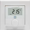 A white wall thermostat with a digital display showing the temperature and mode. Produktbild-Vorschau