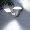 A motion-activated LED floodlight mounted on a brick wall. Produktbild-Vorschau