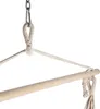 Close-up of a hammock chair's suspension system, showing the metal chain, carabiner, and rope attachment to a wooden spreader bar. Podgląd zdjęcia produktu