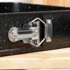 A close-up of a black springform cake pan with a speckled pattern and a silver latch mechanism, resting on a wooden surface. Náhľad obrázku produktu
