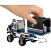 A hand is shown attaching a trailer to a LEGO truck. The trailer has a Jurassic World logo and a minifigure inside. Produktbild-Vorschau