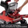 A person is inserting batteries into a red snow blower. Produktbild-Vorschau