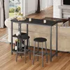 A bar table set with two bar stools placed in a living room setting next to a sofa. Náhľad obrázku produktu