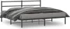 A black metal bed frame with a headboard, covered with bedding, shown from a side angle against a white background. Náhľad obrázku produktu