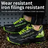 A pair of black and neon green work shoes worn by a person, with a background of metal shavings. Produktbild-Vorschau