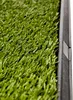 Close-up of artificial grass with a black border. Produktbild-Vorschau