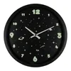 A black wall clock with a space-themed design, featuring glow-in-the-dark numbers and celestial elements. Náhled obrázku produktu