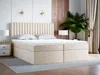 A bedroom scene featuring a bed, nightstand, and plant.