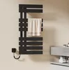 A black electric towel warmer mounted on a light beige wall, with a towel draped over one of its bars. A small black control unit is attached to the wall to the left of the warmer. Produktbild-Vorschau