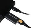 A close-up shot of a black PS2 to HDMI adapter connected to a black PlayStation 2 console. Náhľad obrázku produktu