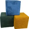 Three corduroy ottomans are stacked and arranged in a corner against a white background. Náhled obrázku produktu