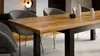 A dining table with chairs in a modern dining room setting. Produktbild-Vorschau