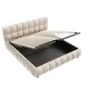 A beige upholstered bed frame with the mattress support lifted to reveal storage space underneath. Náhľad obrázku produktu
