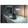 A man is working on a construction site with a portable LED work light. Anteprima dell’immagine prodotto