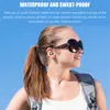 A young woman wearing sunglasses and a backpack, with earbuds in her ears, against a blue sky. Produktbild-Vorschau