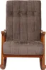 A front view of a brown rocking chair with a wooden frame. Podgląd zdjęcia produktu