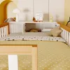 A child's bed with bedding and a shelf unit above it, decorated with small items. Anteprima dell’immagine prodotto